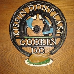 Vintage Cast Iron Trivet, "Kissin' don't last"!